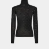 Turtleneck-top i ull som sitter som et ekstra hudlag